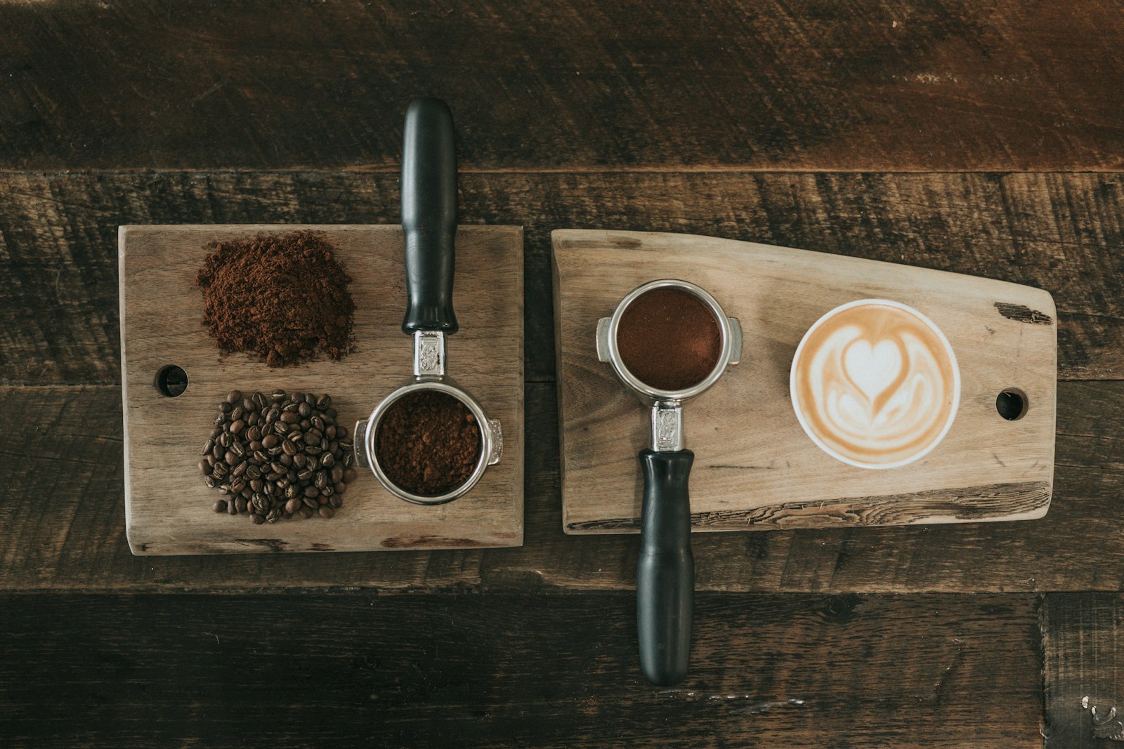 Espresso tools with ground coffee and a latte